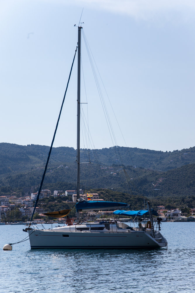 Elegant profile of the Lauren sailing in tranquil waters with a scenic mountainous backdrop.