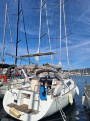 Beleza docked in a vibrant marina, showcasing its sleek lines and elegant design.