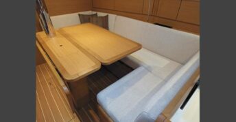 Elegant dining area aboard Topaze, featuring warm wood finishes and comfortable seating.