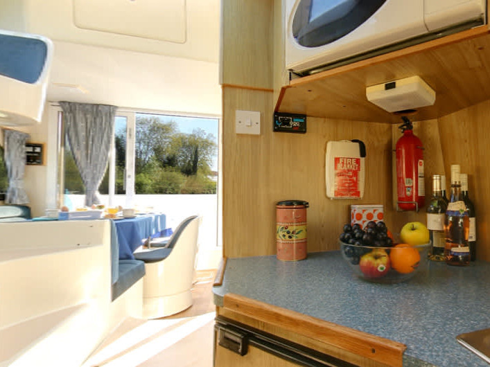 Bright and inviting galley of Caprice - Comfort 17 featuring modern amenities and fresh fruit.