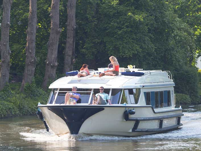 Vision4 - Comfort Plus 5 gliding smoothly through serene waters, showcasing a stylish exterior and relaxed guests.