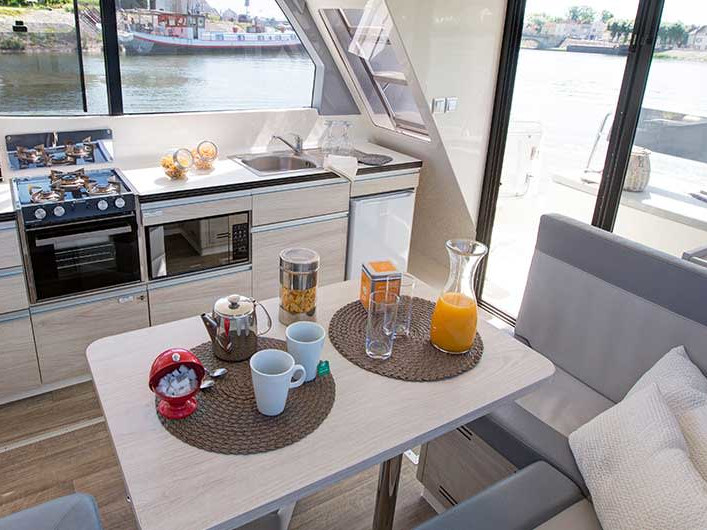 Bright and modern galley on Horizon 2 - Premier 14, featuring elegant dining setup and natural light.