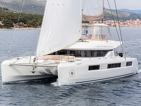 Sailing gracefully, Sunshine showcases its sleek profile and elegant hull against a serene backdrop.