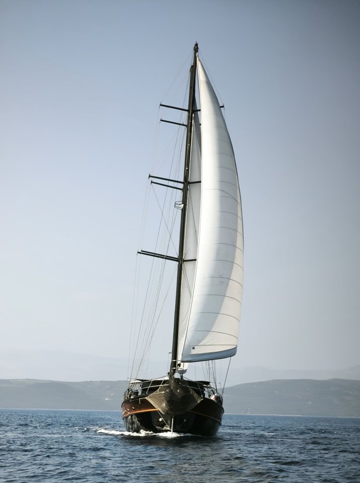 Stella Maris gracefully sailing with full sails, showcasing its elegant profile against a clear sky.