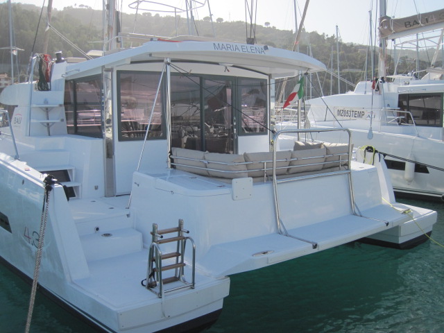 Elegant exterior of the Maria Elena showcasing spacious aft deck and sleek lines.