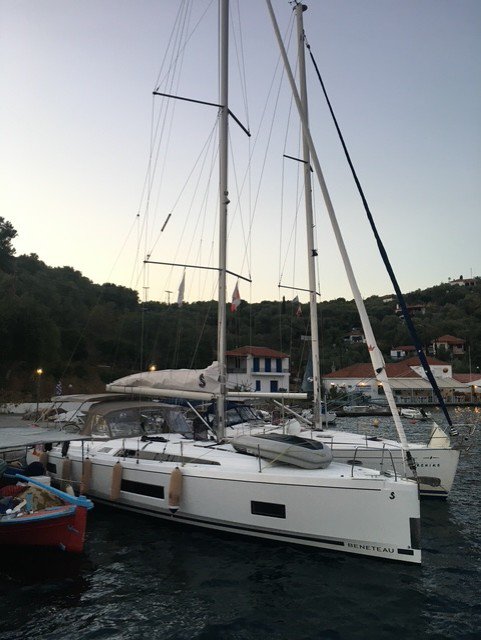 Elegant Filira docked at a picturesque marina, showcasing its sleek hull and masts.