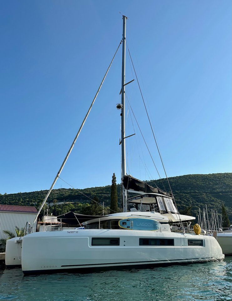 Princess Claire showcasing a sleek profile against a clear blue sky in a marina.