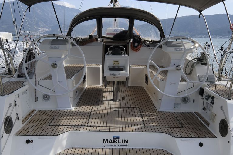 Sleek interior helm of Marlin featuring elegant wood flooring and modern navigation equipment.