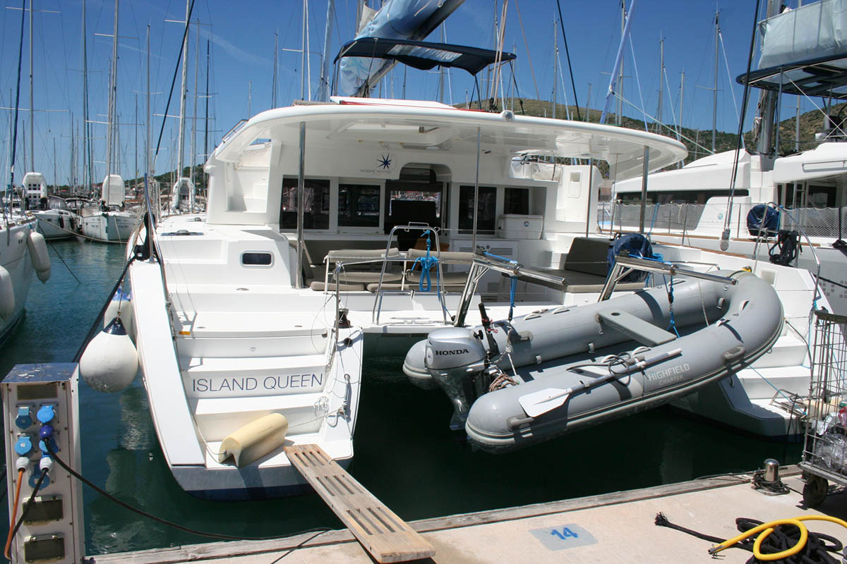Elegant profile of Island Queen docked, showcasing sleek lines and luxurious amenities.