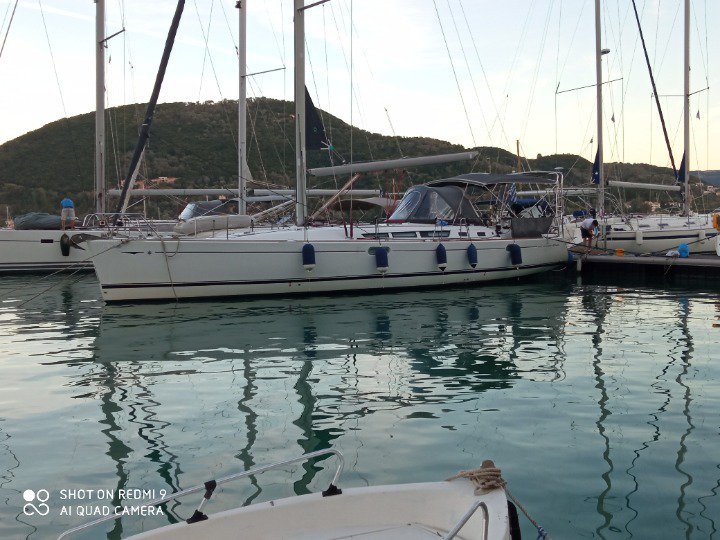 Sleek profile of Family yacht docked in a serene marina, reflecting tranquil waters.
