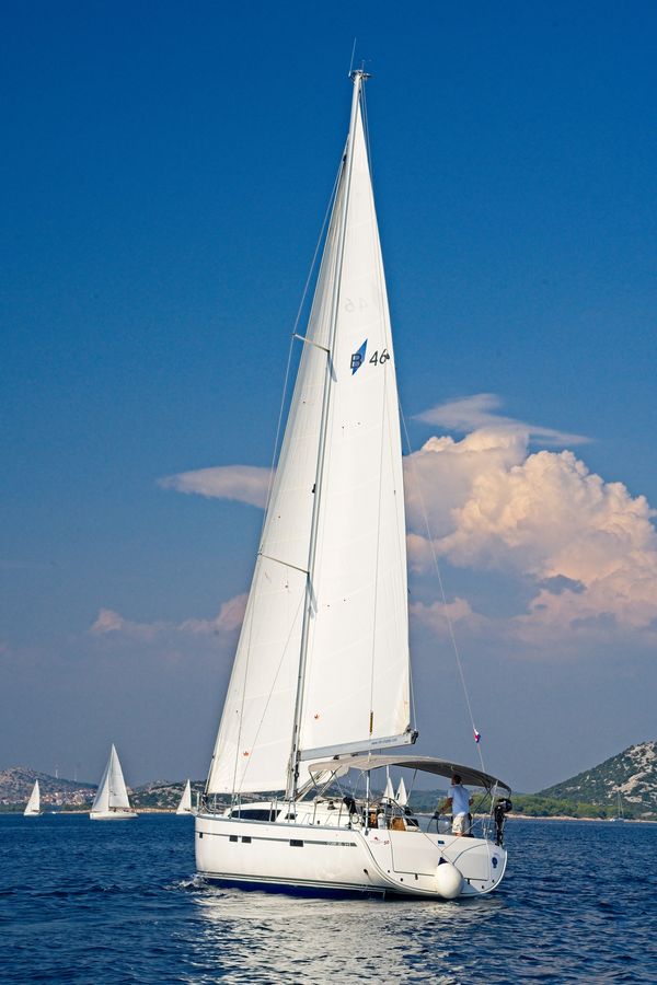 MH 50 gliding gracefully through azure waters under a clear blue sky.