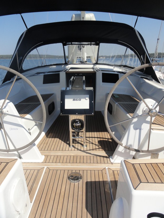 Spacious helm of Riana featuring dual steering wheels and elegant teak decking.