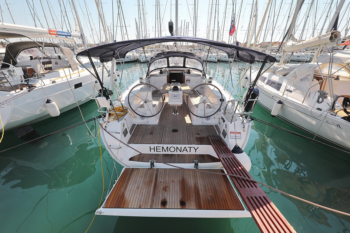 Elegant stern view of Hemonaty showcasing polished wood, spacious deck, and inviting cockpit.