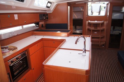 Sleek, modern galley of Baby Blue 2 featuring warm wood finishes and ample storage.