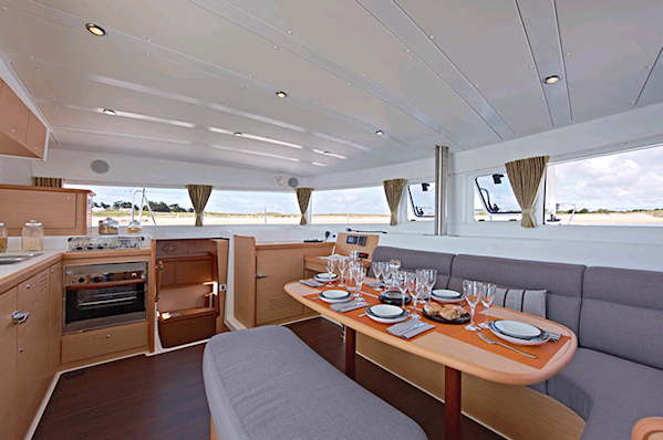 Elegant dining area aboard Olympios Zeus, featuring modern furnishings and abundant natural light.